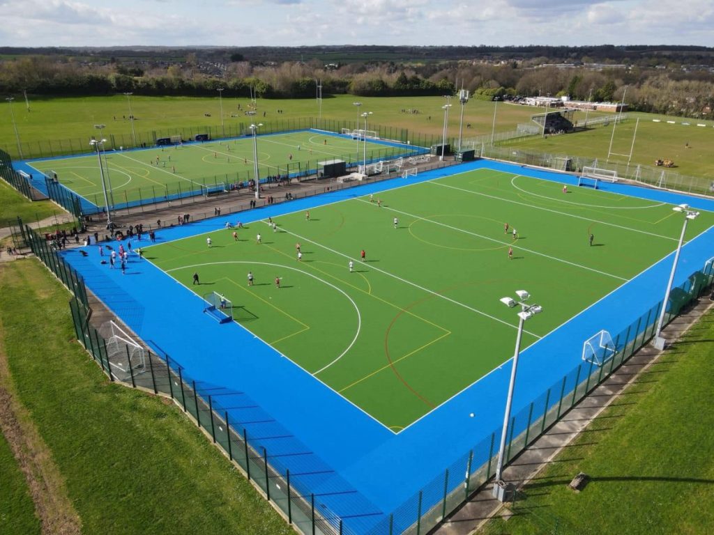 Aerial view of dry hockey pitch at Basingstoke with green pitch and blue surrounding installed by AS Sports